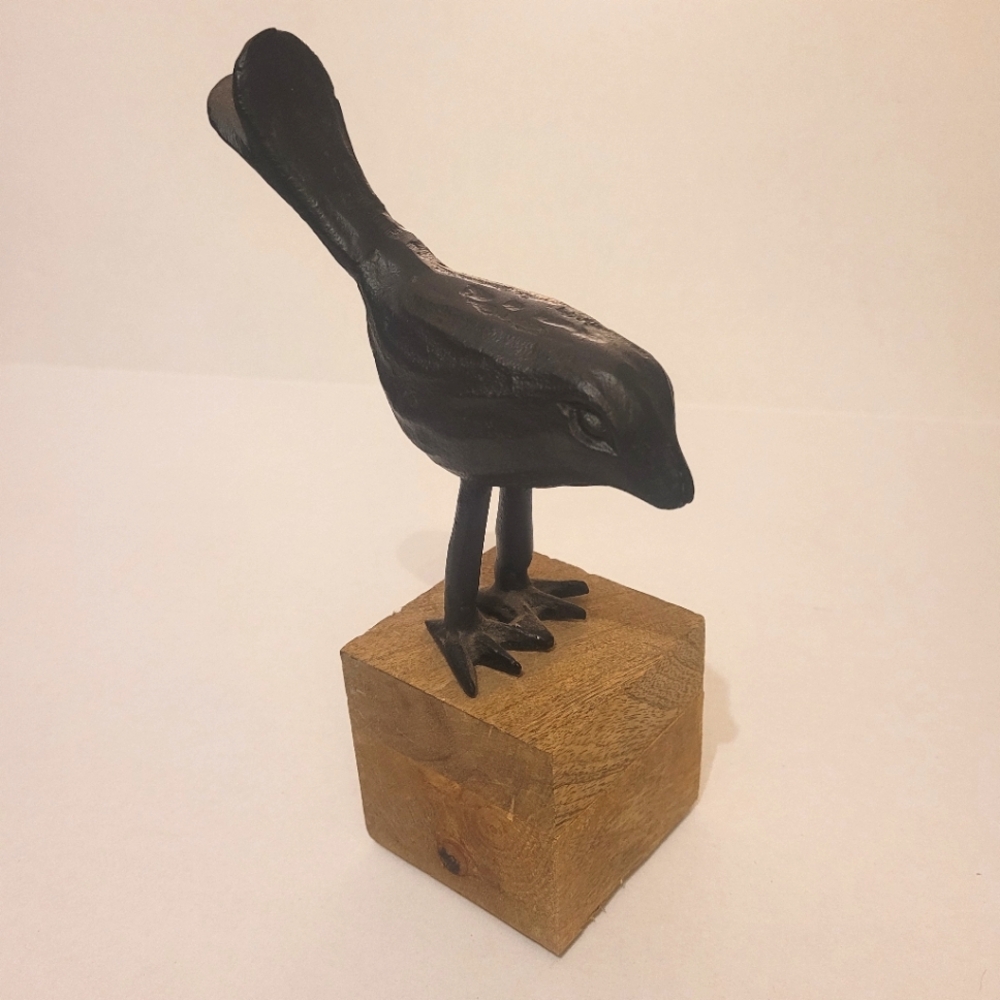 Bird statue on a wooden block decor